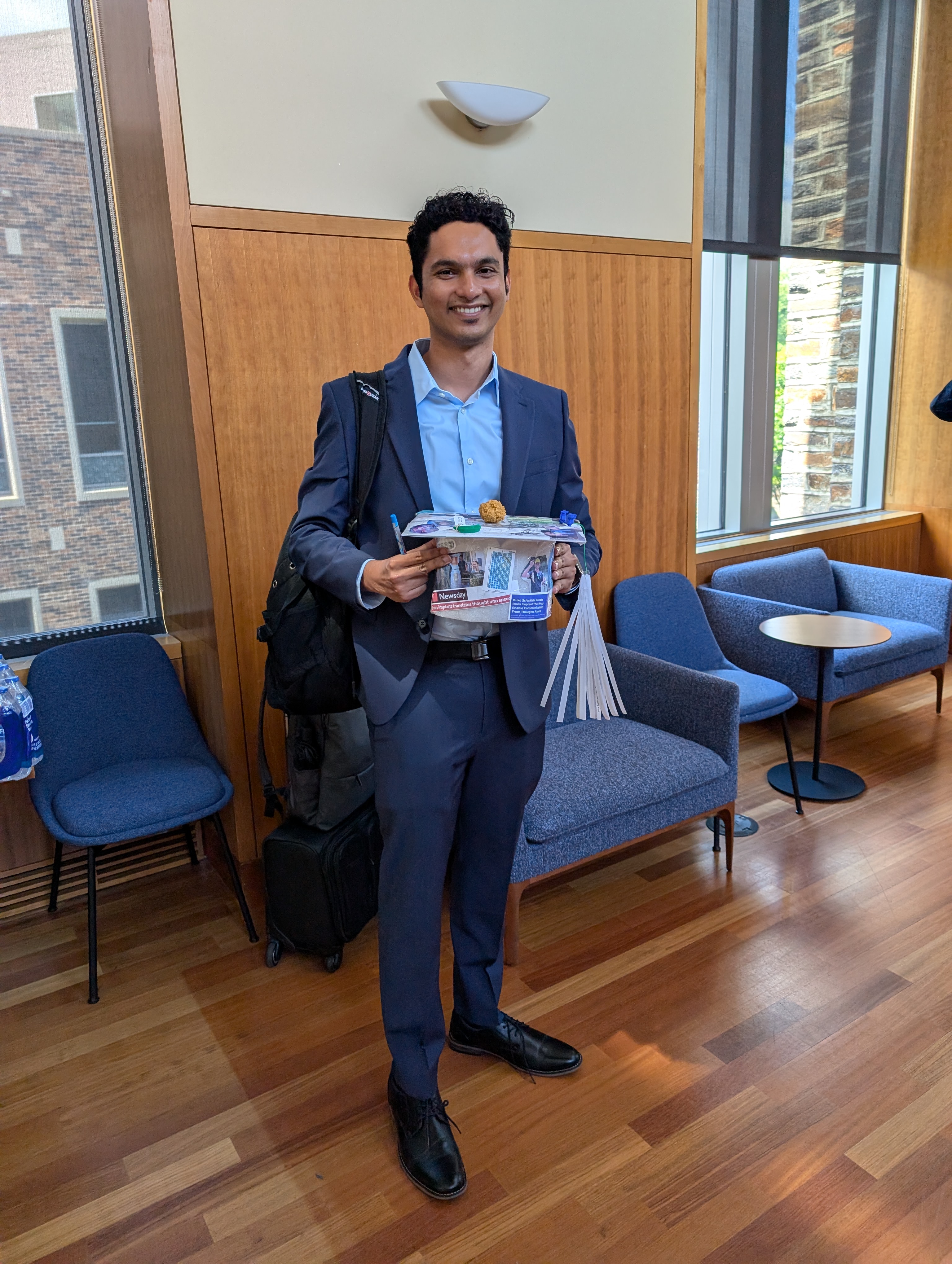 Kumar with his dissertation "graduation cap".